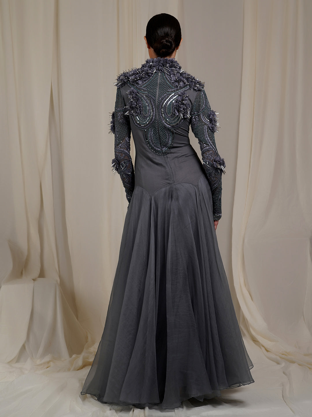 A  grey organza silk floor length gown with high neck line