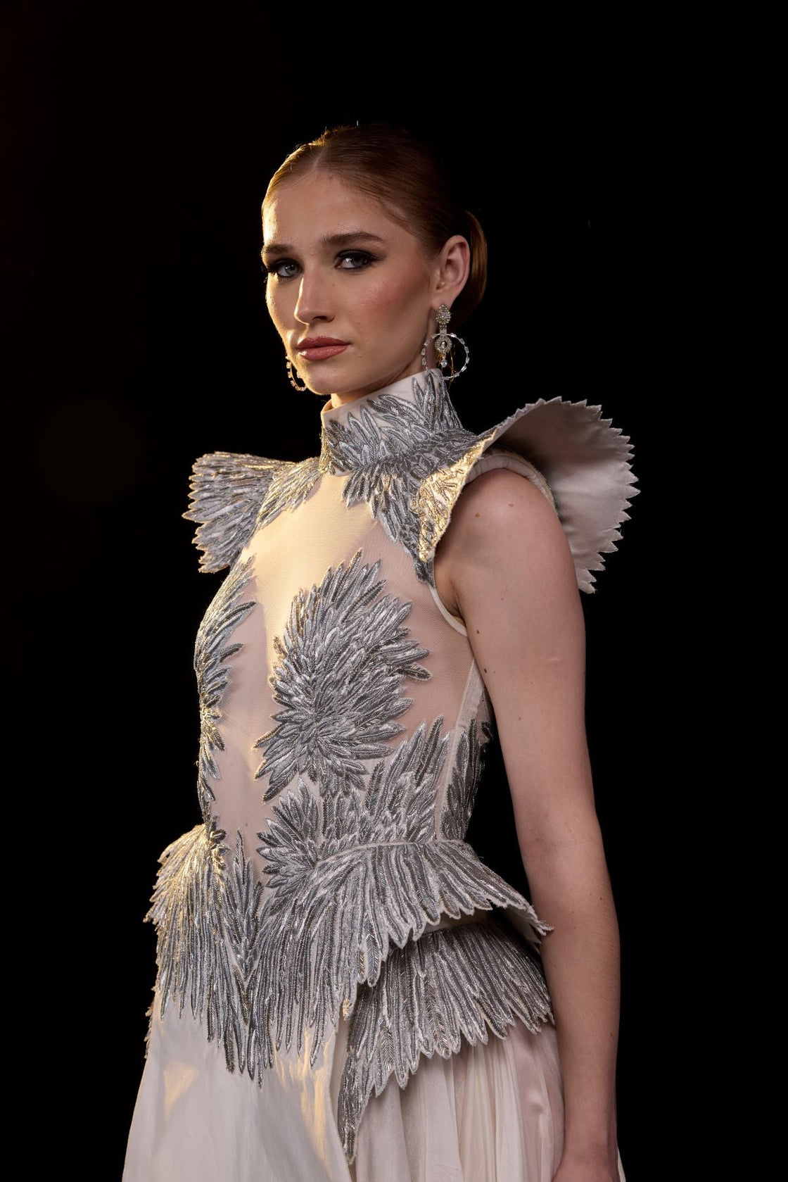 A striking evening gown featuring a sculptural.