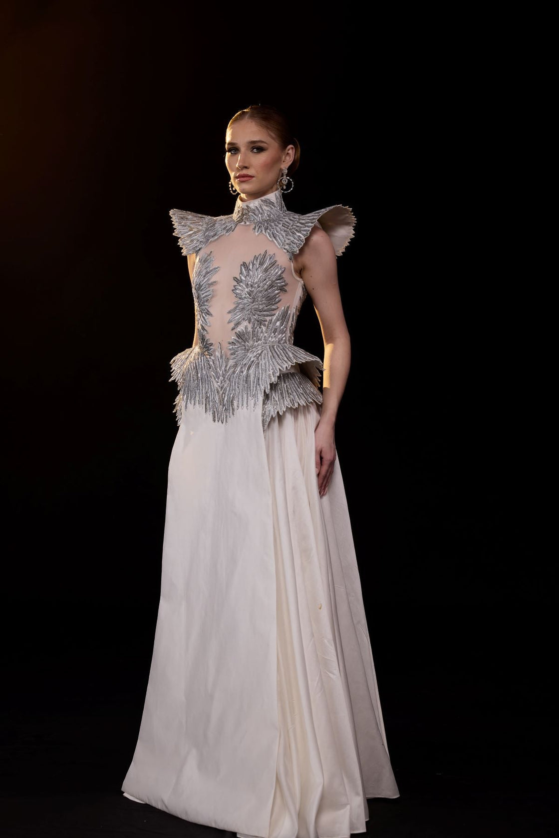 A striking evening gown featuring a sculptural.