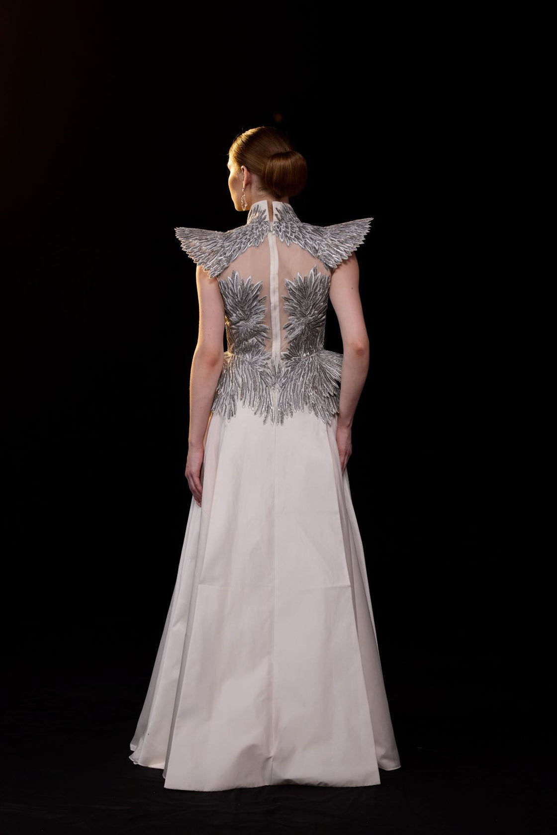 A striking evening gown featuring a sculptural.