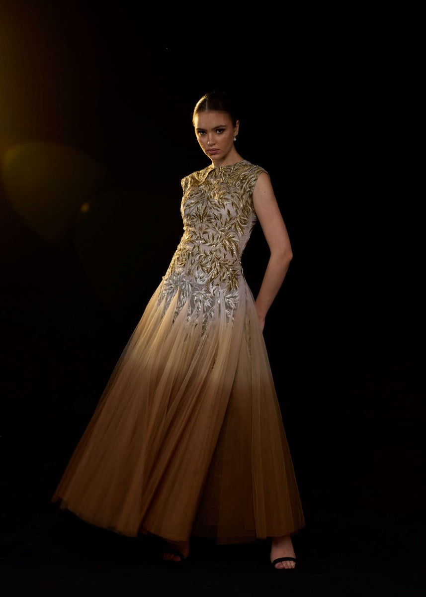 A stunning ombré tulle gown featuring intricate gold and silver