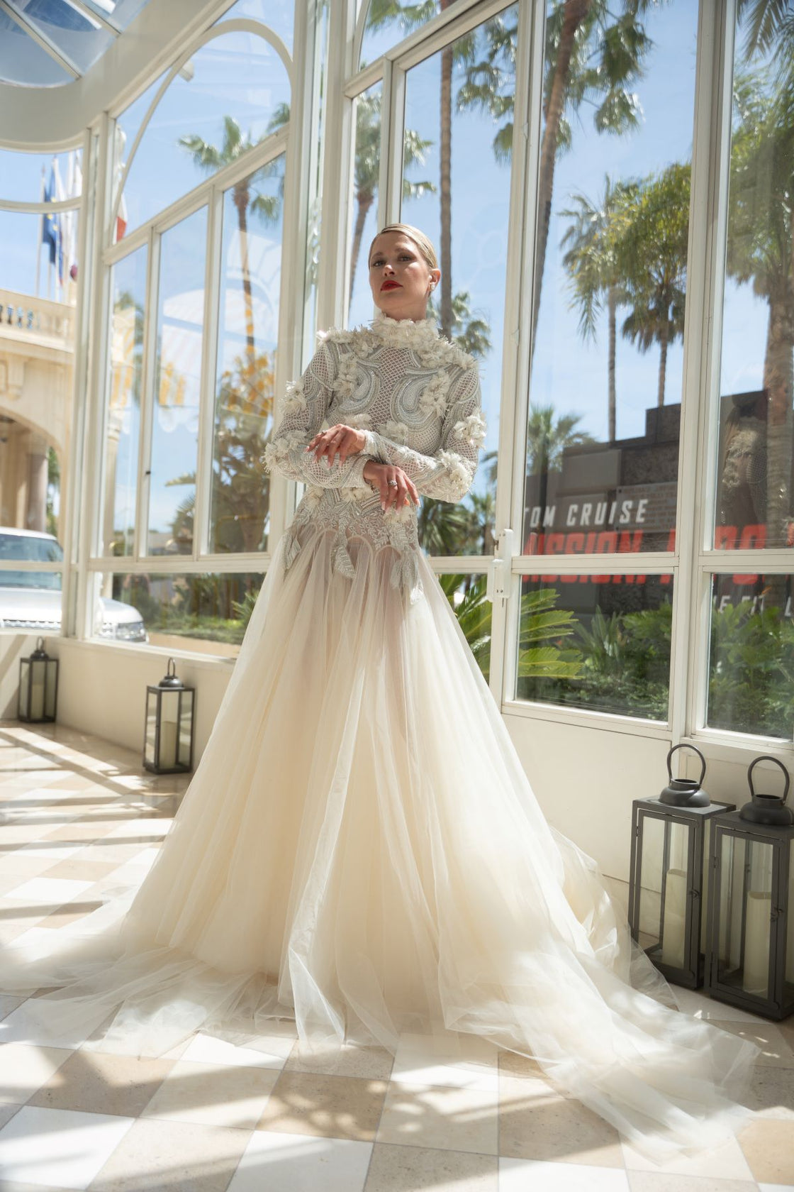 A white  floor length gown with 3d work details & zero neck line.