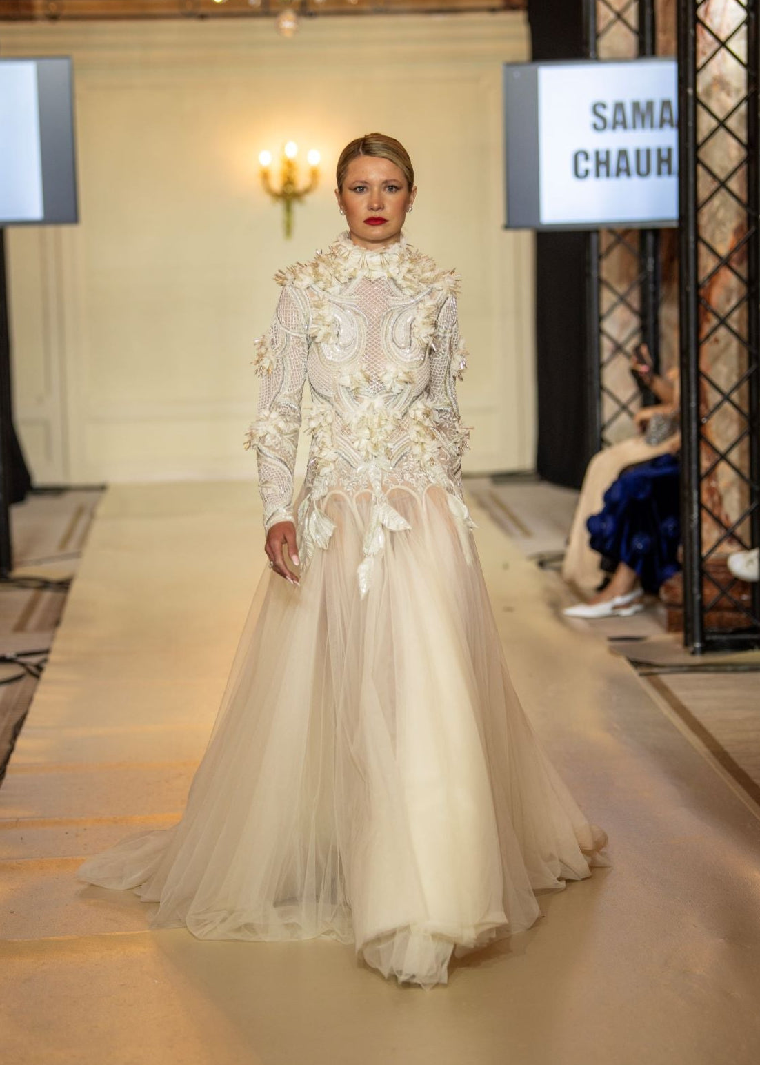 A white  floor length gown with 3d work details & zero neck line.