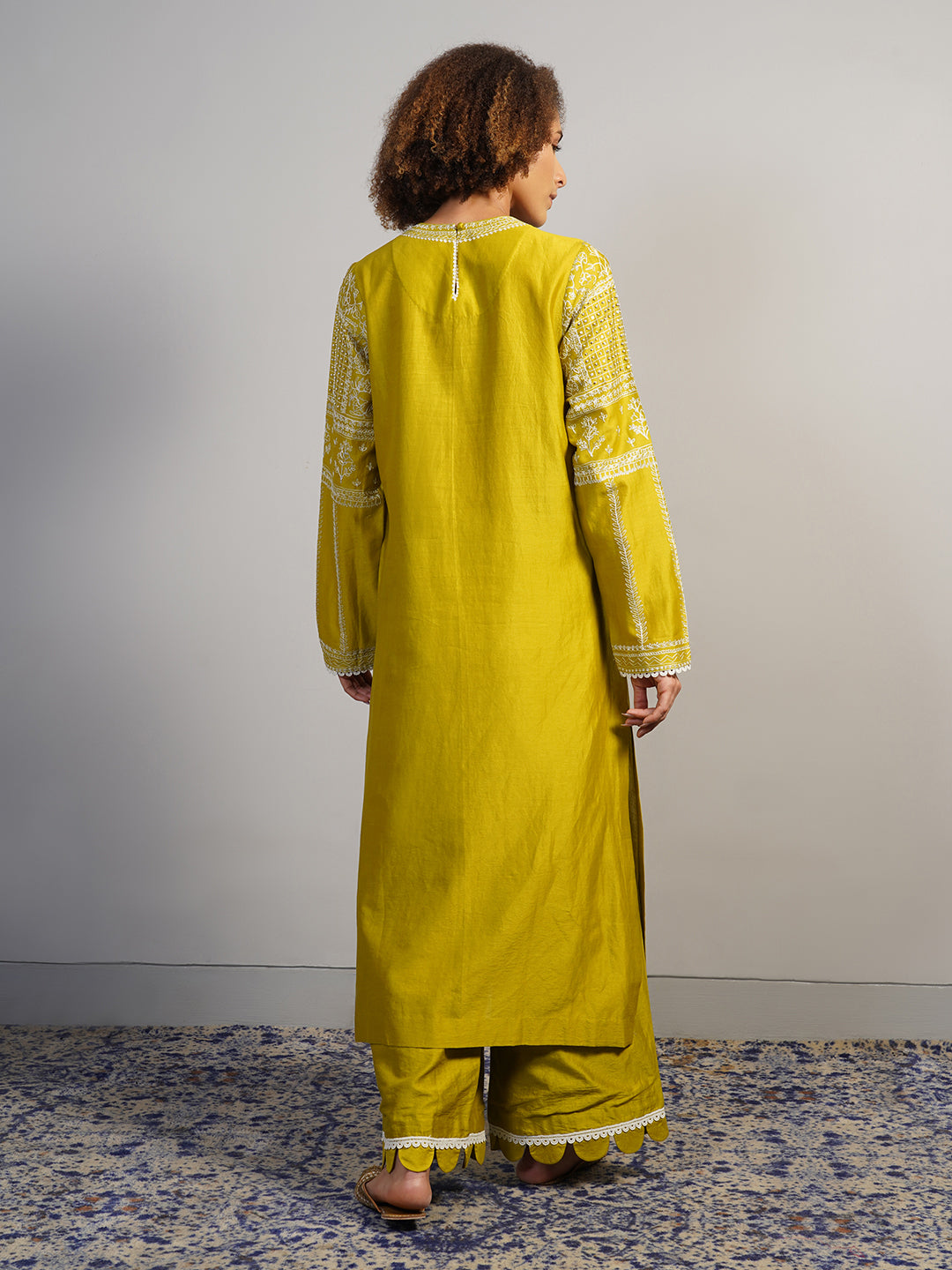 A lovely warm olive cotton silk suit set that is intricately embroidered in Aari work