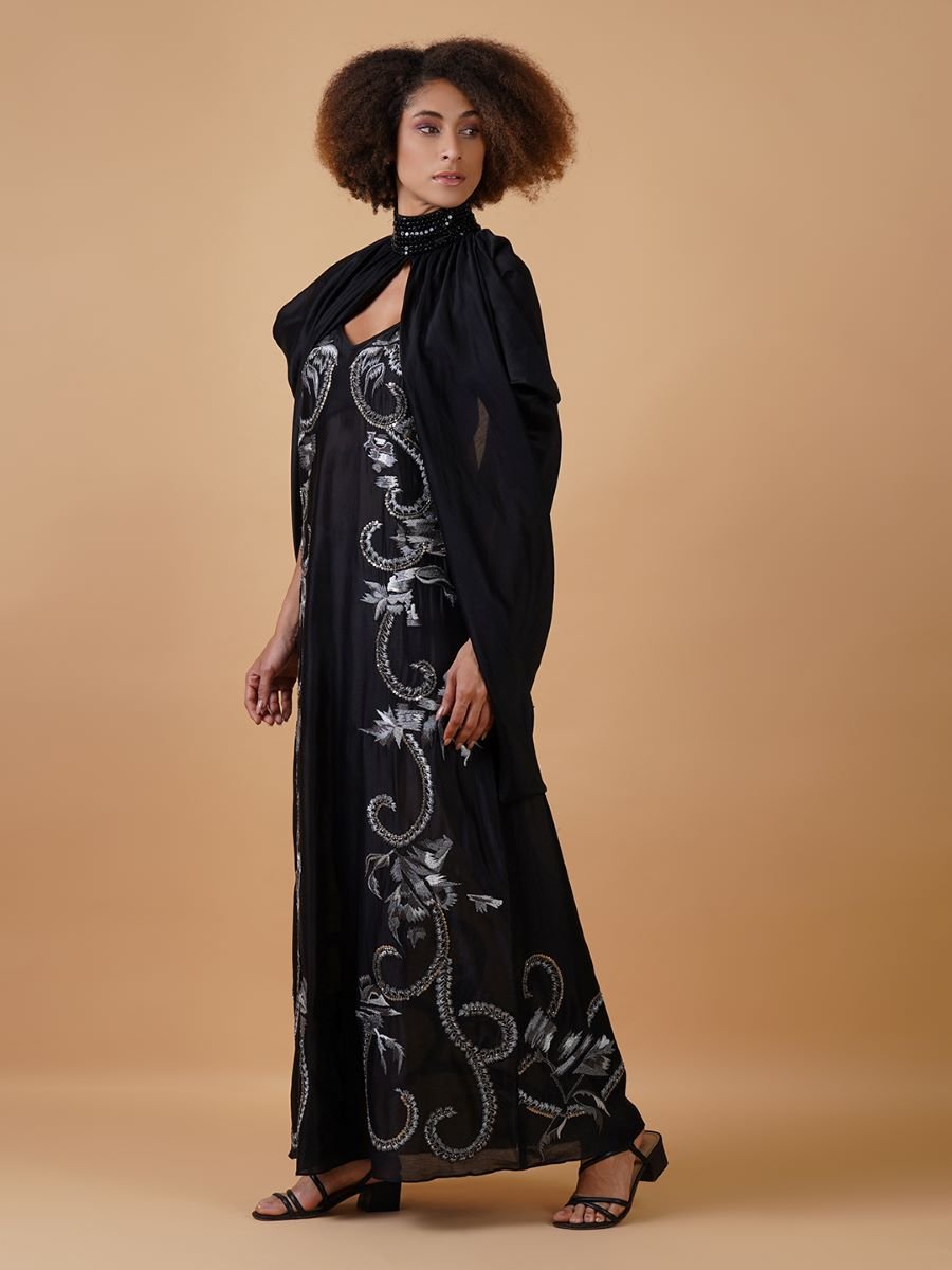 A long black cotton silk dress that has panels of silver zari embroide