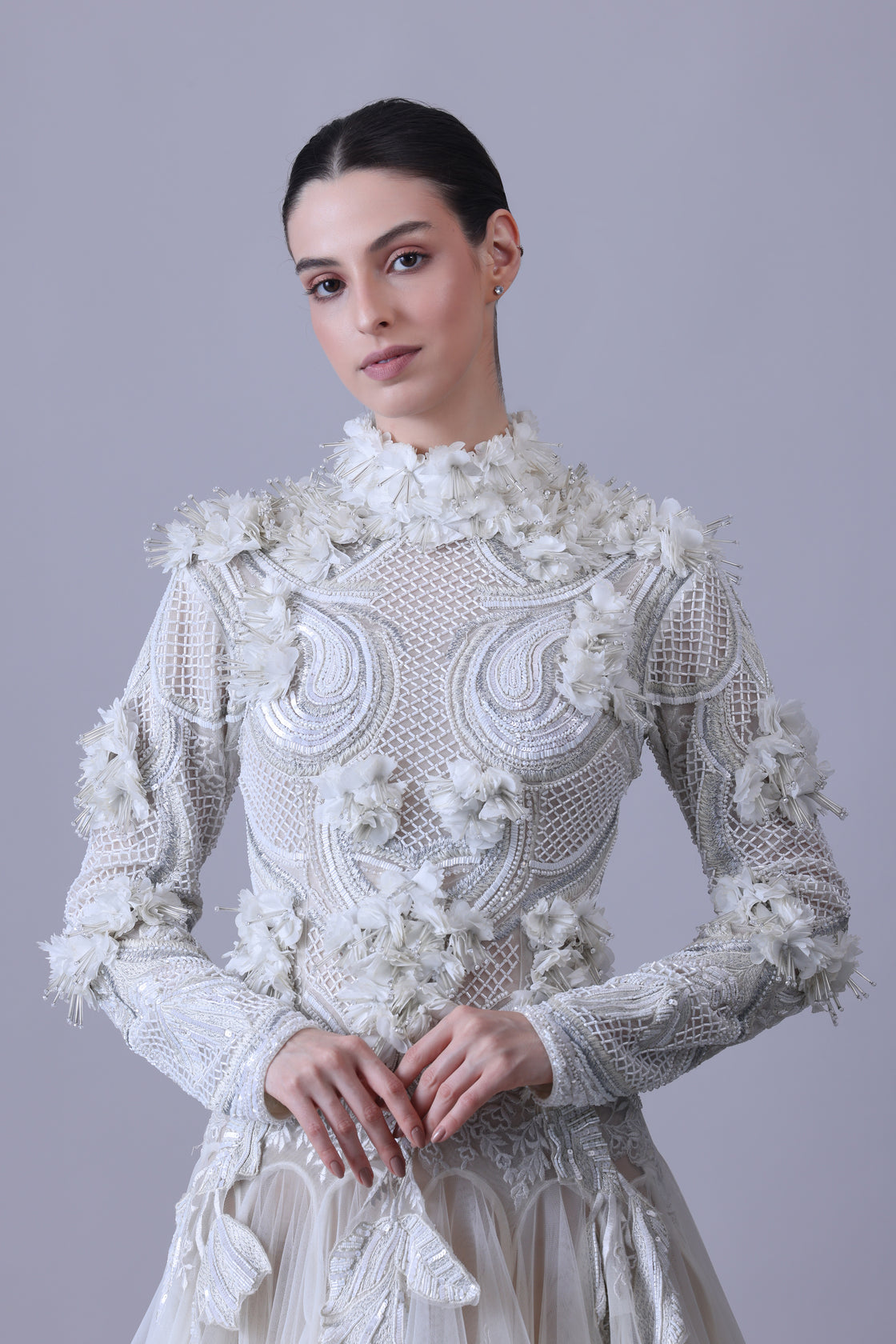 A white  floor length gown with 3d work details & zero neck line