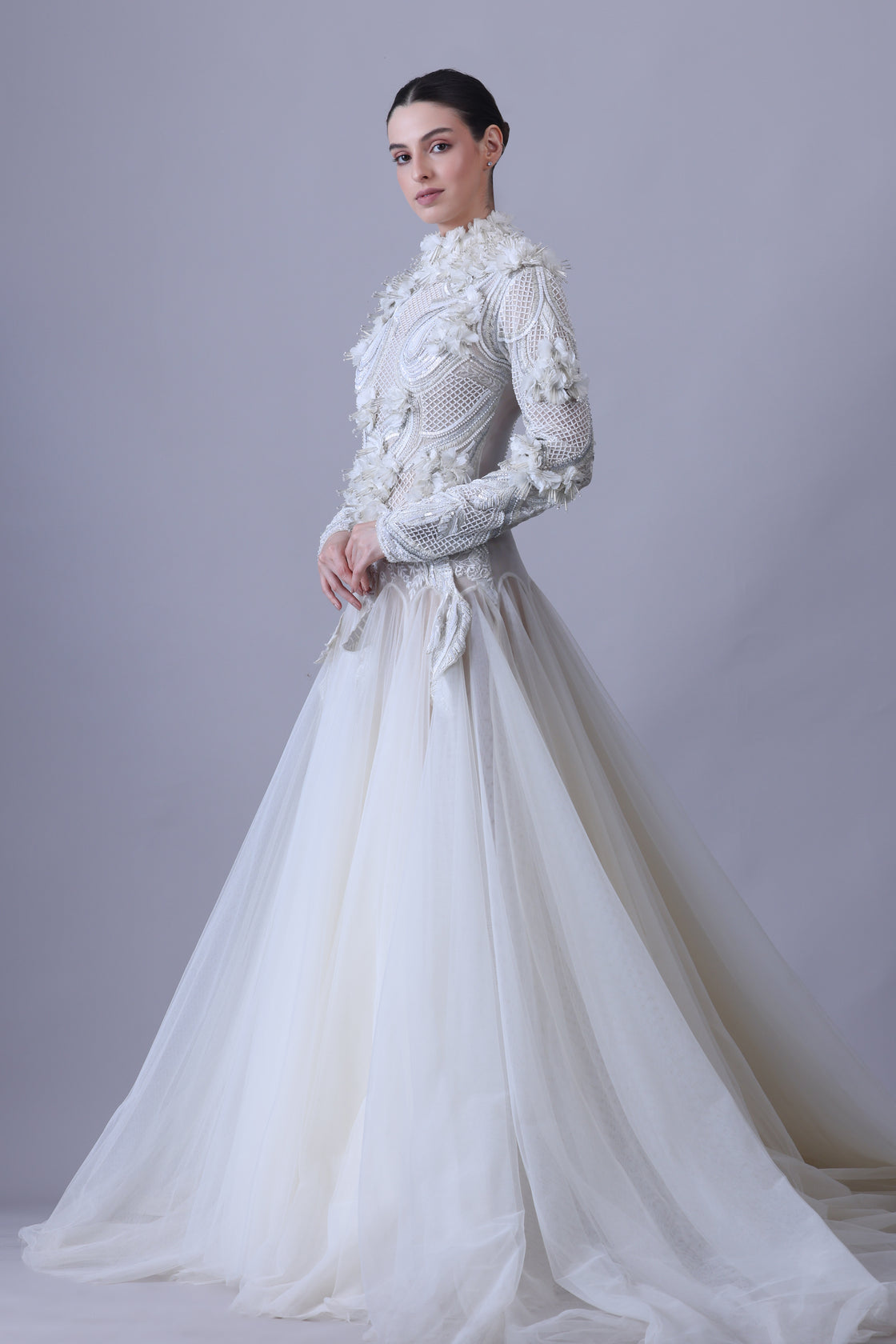 A white  floor length gown with 3d work details & zero neck line