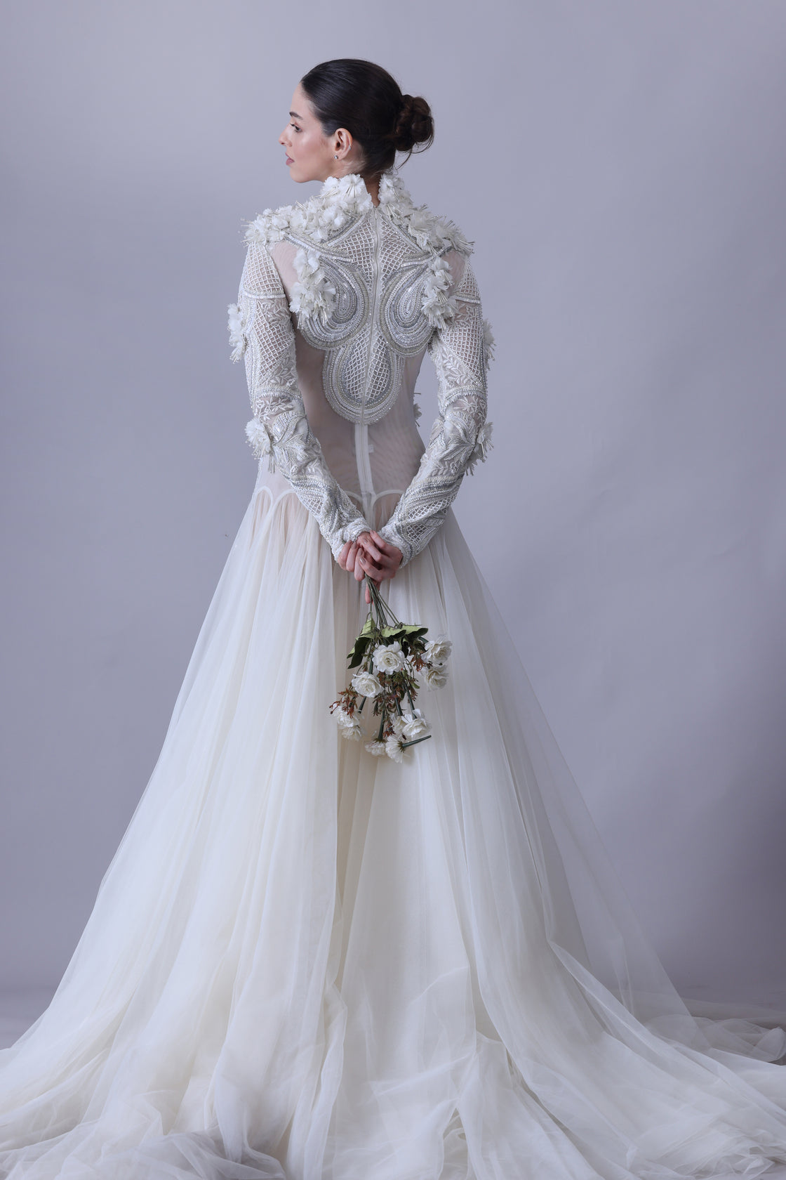 A white  floor length gown with 3d work details & zero neck line