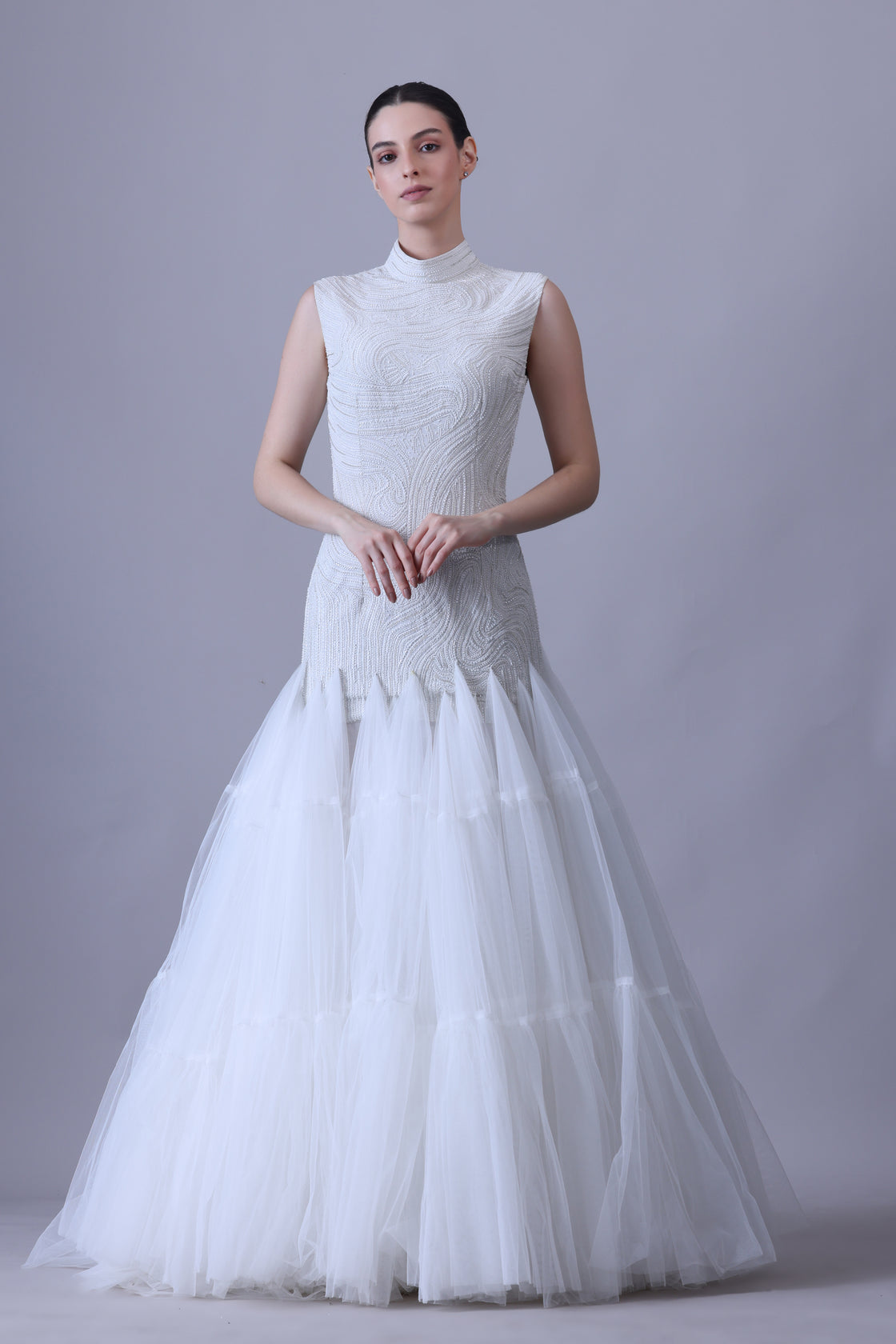 A elegant sleeveless gown features a high neckline and a fitted