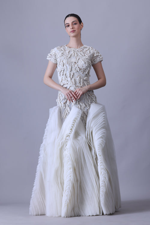 A exquisite gown features a sculpted bodice with ornate bead and thread embroidery