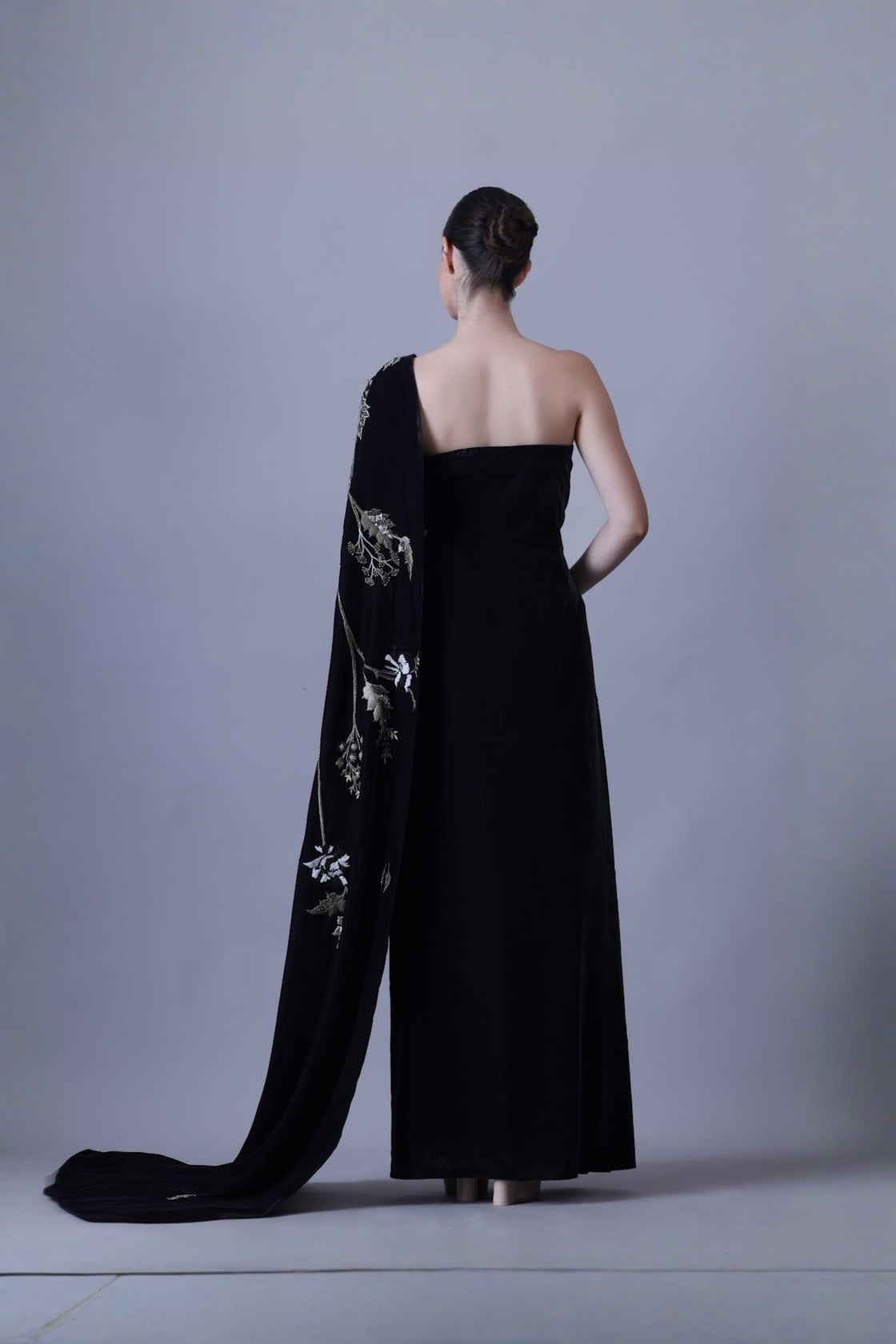 Elegant Black Gown Featuring A One-Shoulder Bodice With Embroidered Detailing