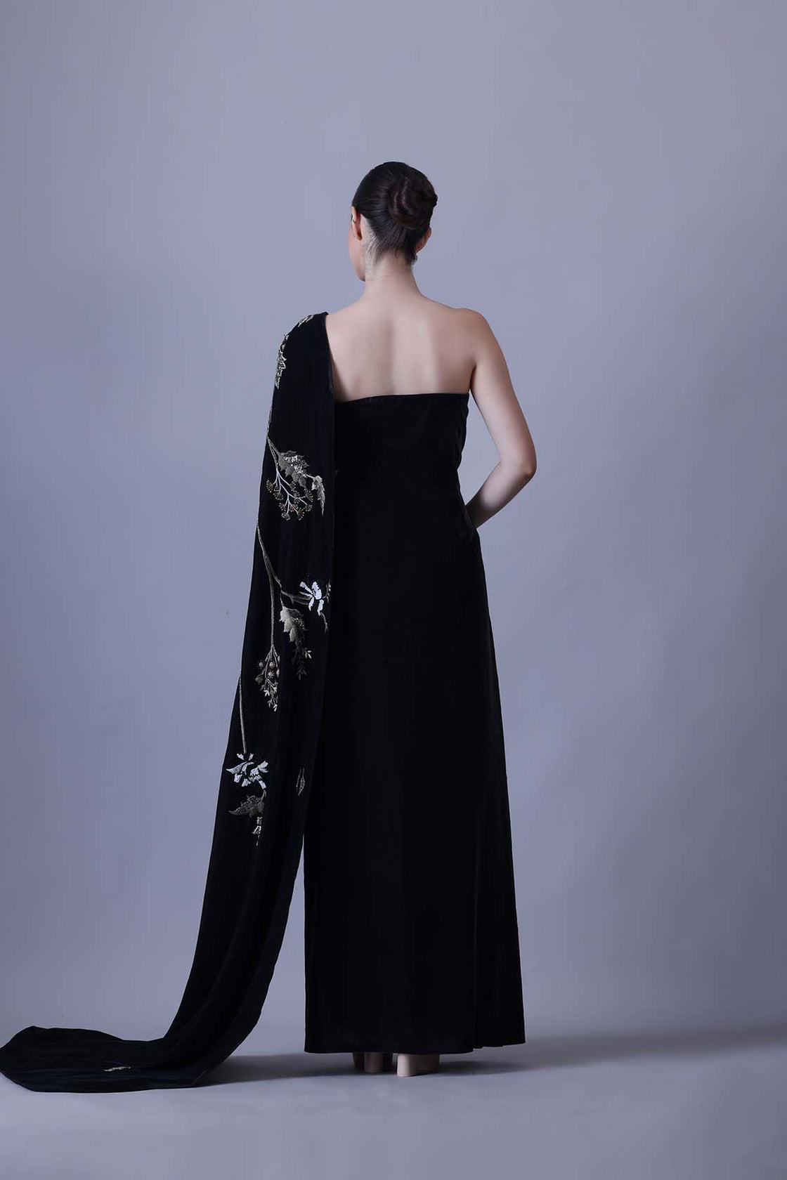 Elegant Black Gown Featuring A One-Shoulder Bodice With Embroidered Detailing