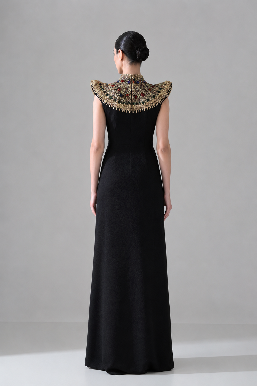 Black Silhouette with Structured Shoulders and Ornate Gold Embroidery