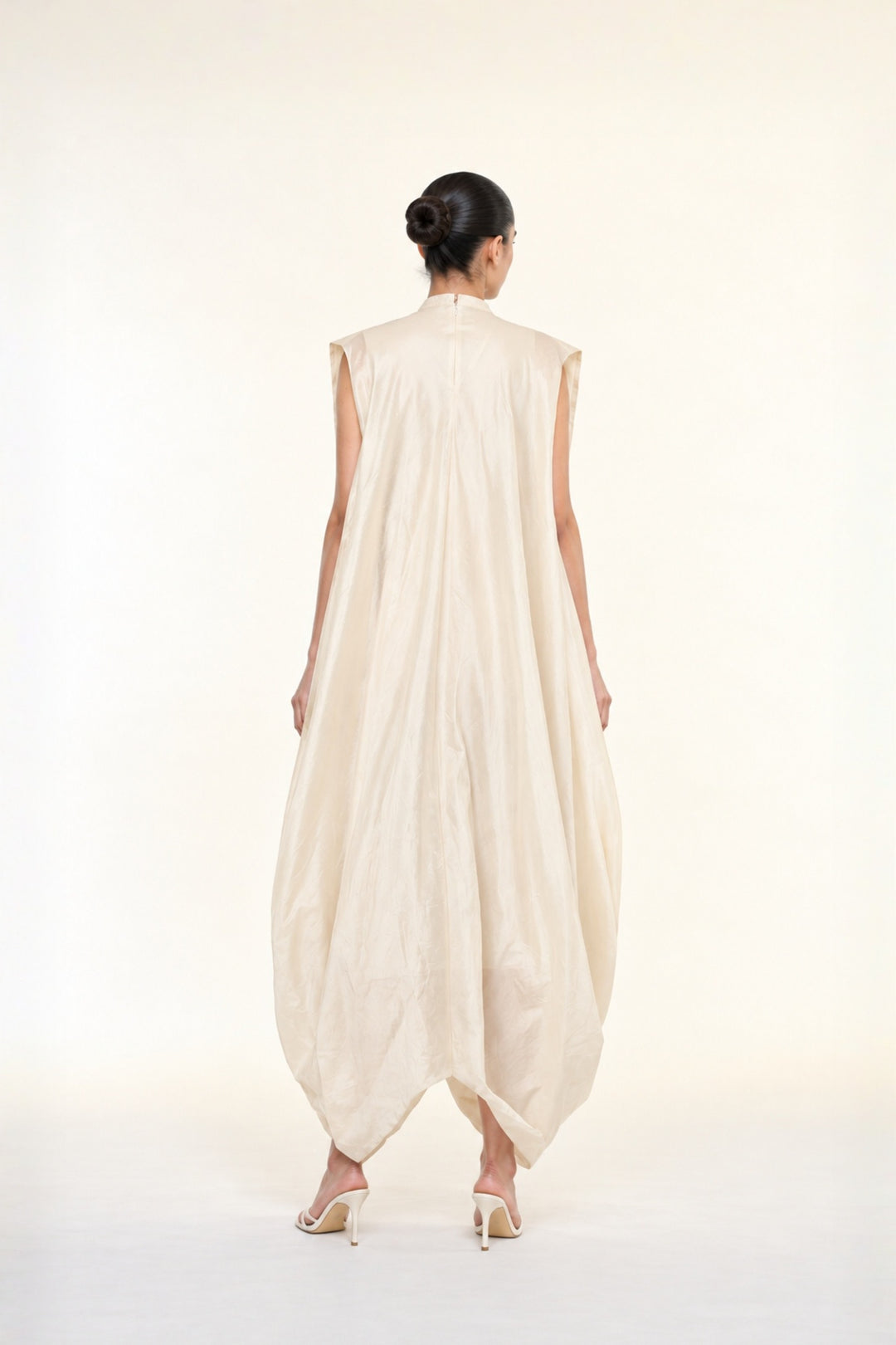 Ivory embroidered draped ensemble featuring floral threadwork, a fluid cowl silhouette, and contemporary cape-inspired styling