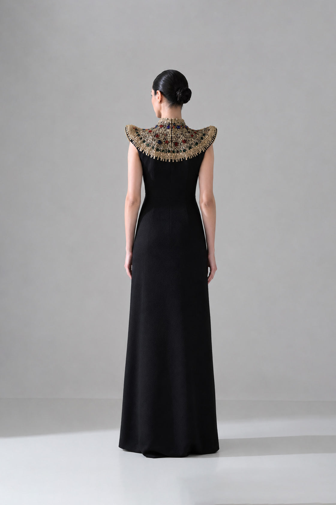 Black Silhouette With Structured Shoulders And Ornate Gold Embroidery