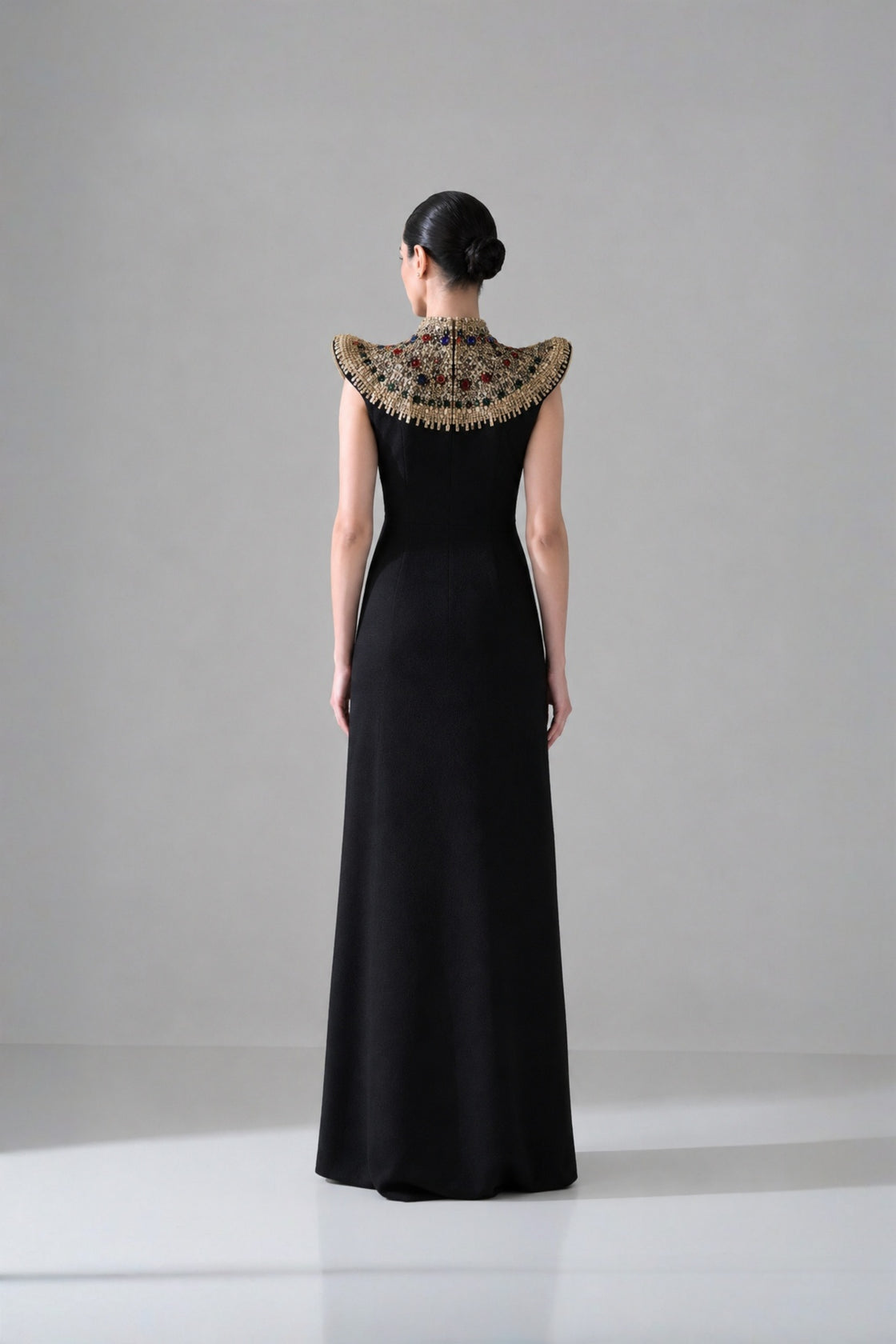 Black Silhouette With Structured Shoulders And Ornate Gold Embroidery