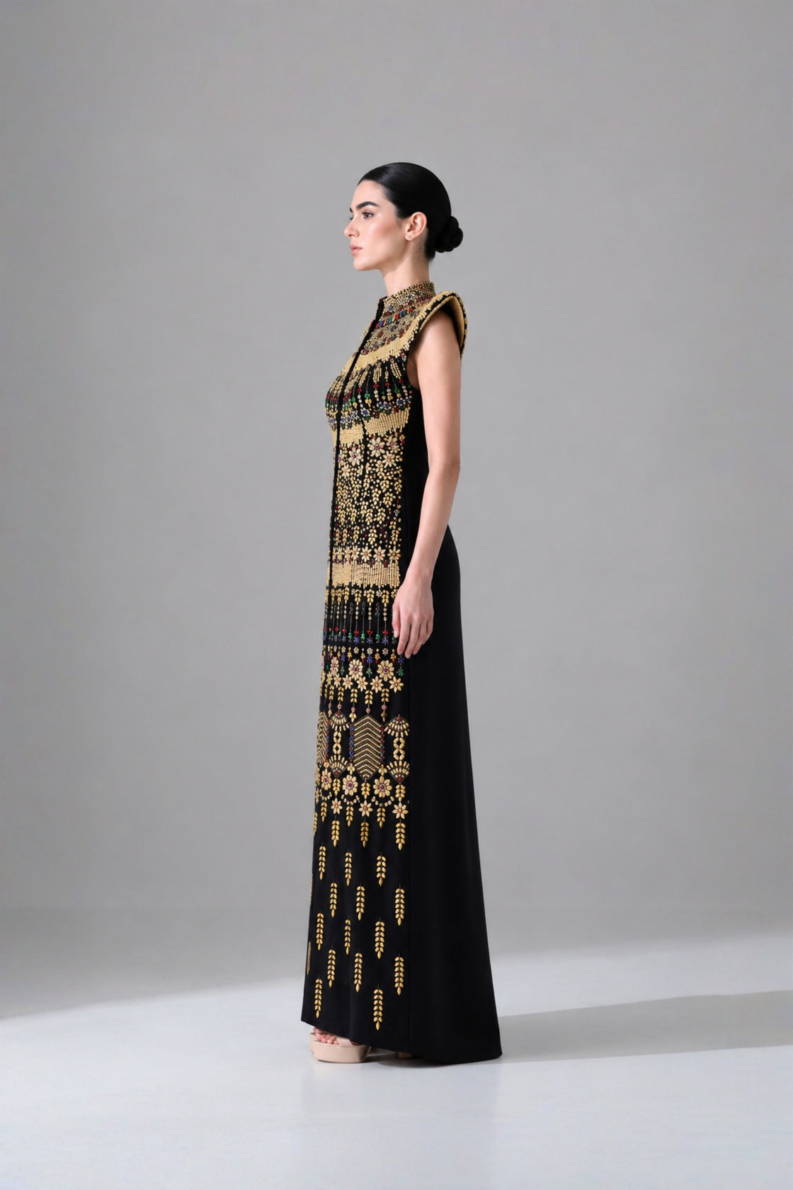 Black Silhouette With Structured Shoulders And Ornate Gold Embroidery
