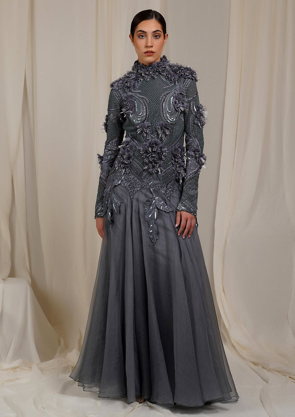 A  grey organza silk floor length gown with high neck line