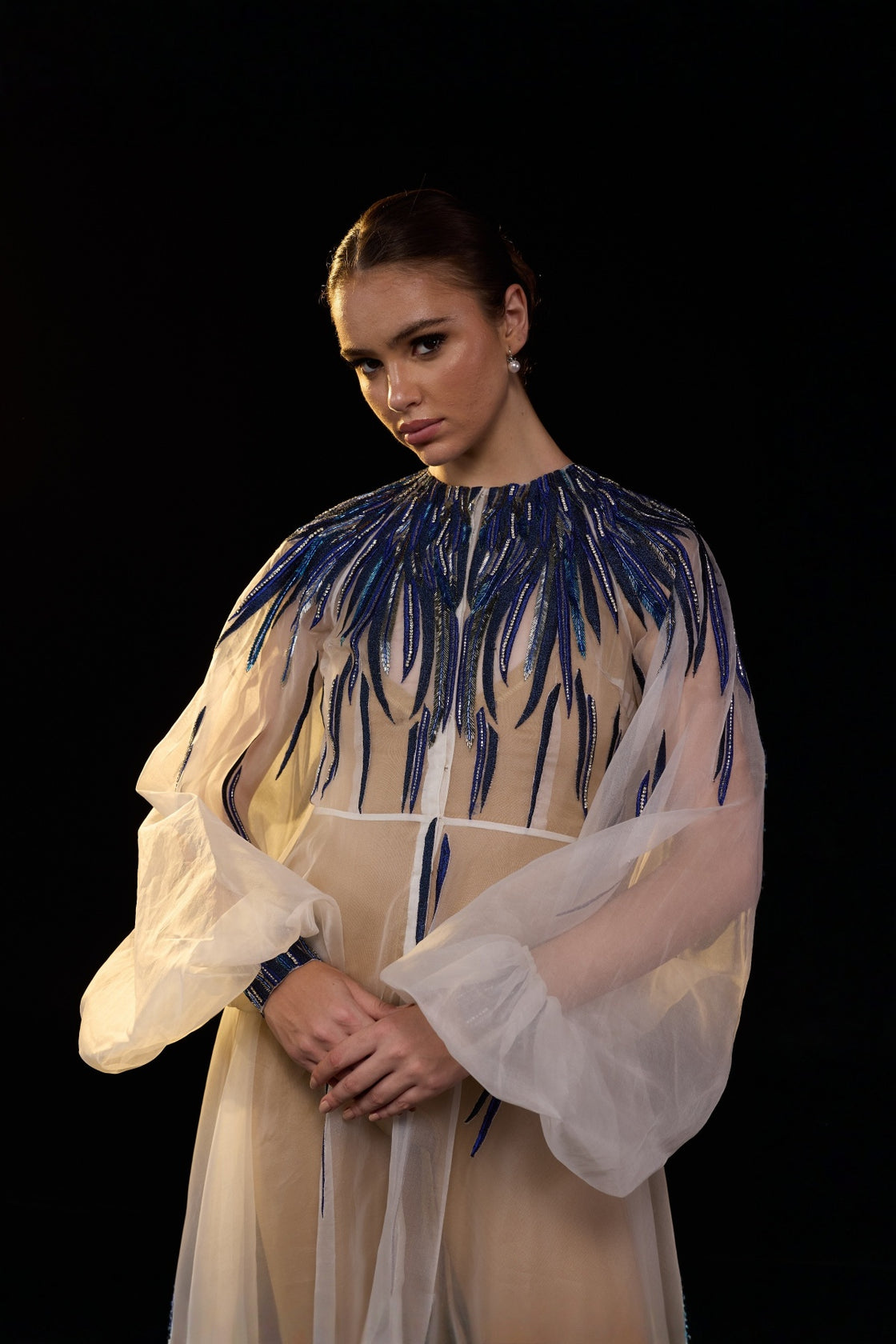 Ivory Sheer Overlay Gown With Cobalt Embellishments And Vibrant Beadwork.