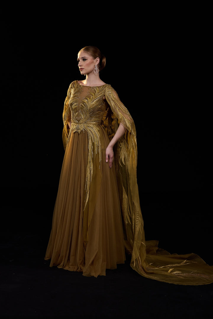 Golden-Bronze Embroidered Gown With Sheer Cape Sleeves , Structured Bodice And Flowy Pleated Bottom.