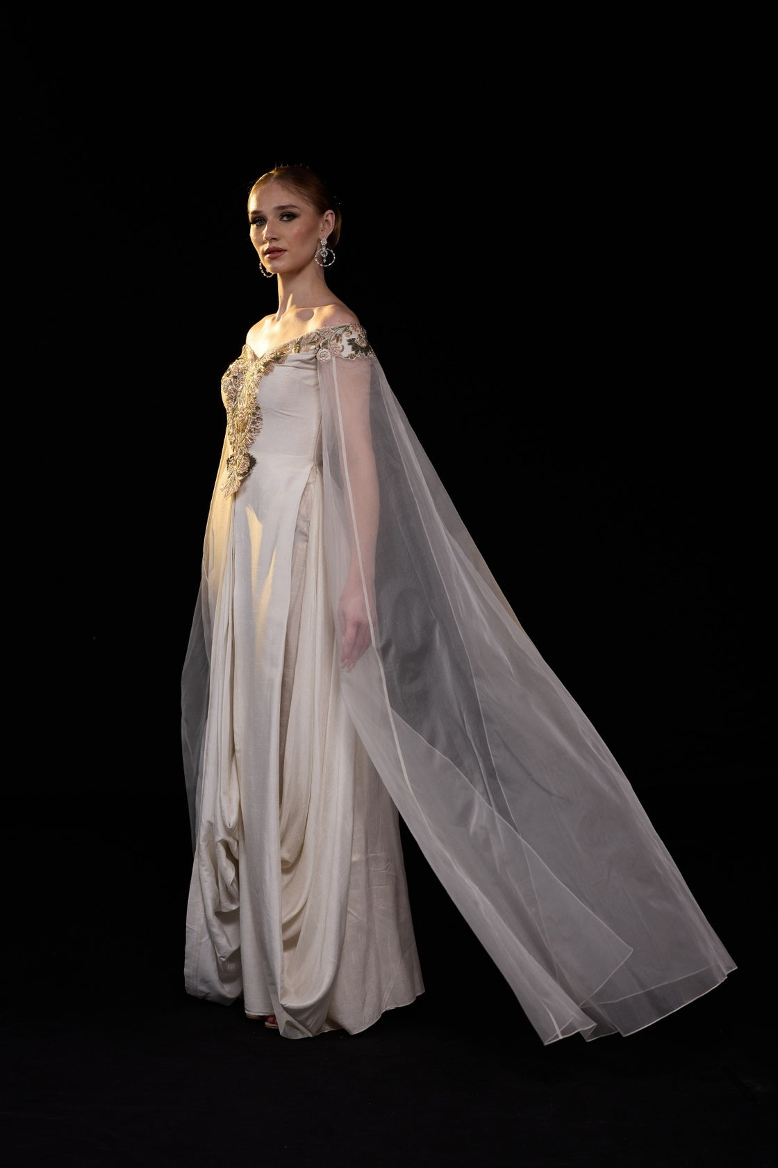 Ivory Off-Shoulder Gown With Floral Embroidery, Sheer Cape Sleeves And A Fluid Floor Length Silhouette