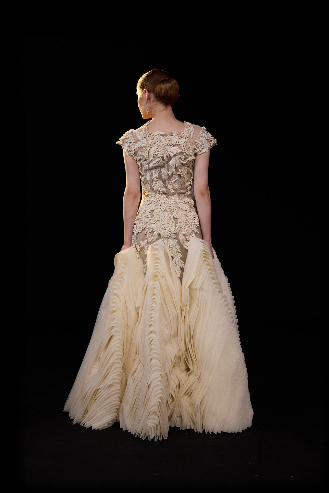 Ivory Embellished Gown With A Floral Applique Bodice , Sheer Detailing And Dramatic Pleats