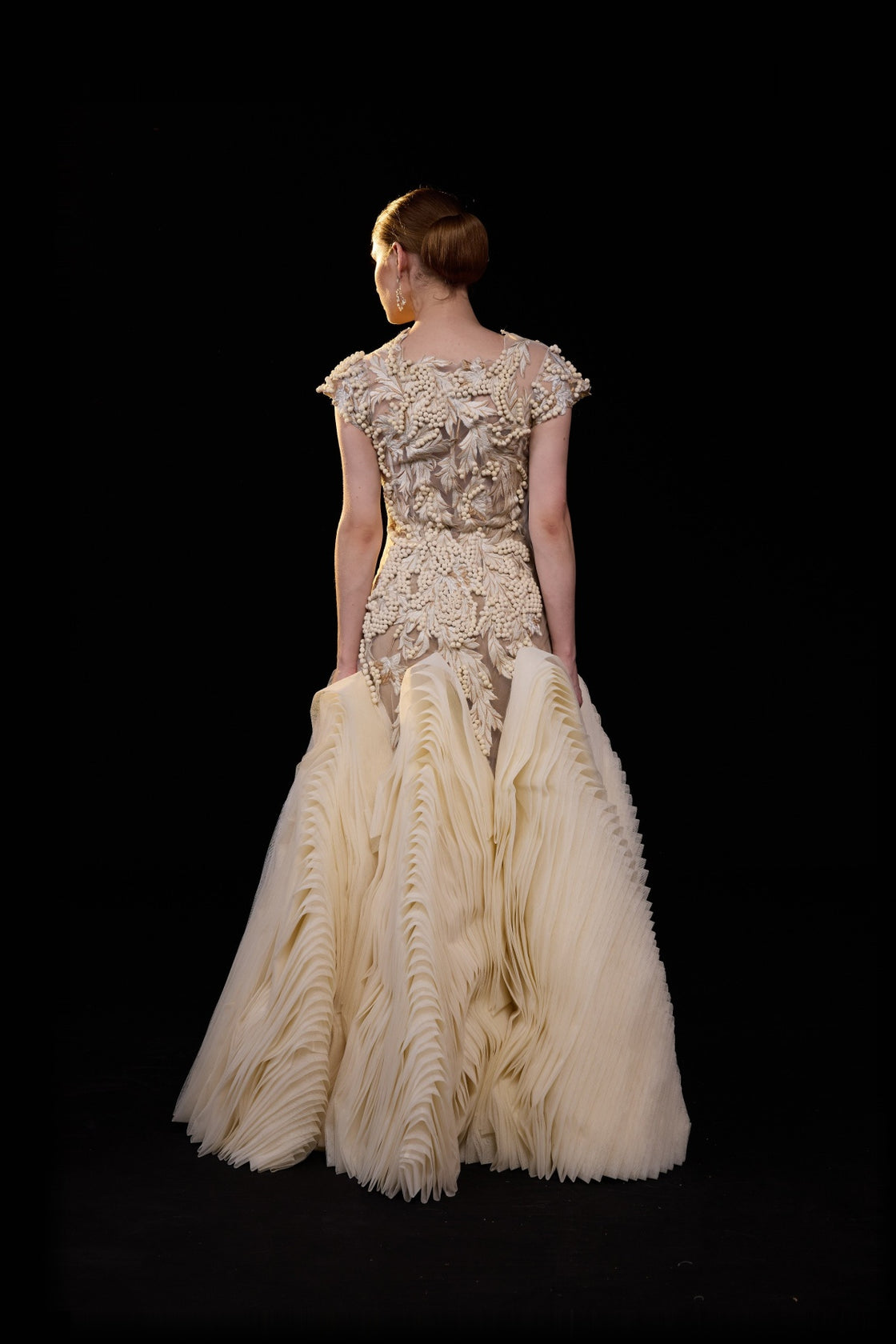 Ivory Embellished Gown With A Floral Applique Bodice , Sheer Detailing And Dramatic Pleats