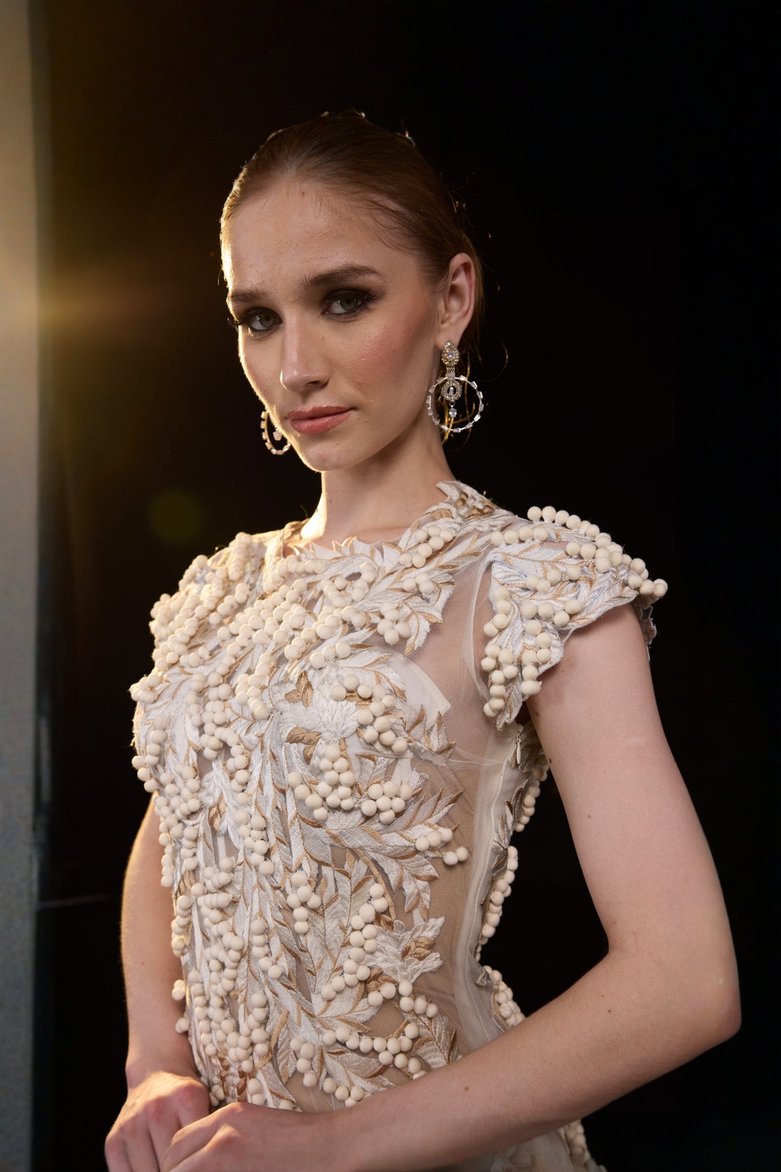 Ivory Embellished Gown With A Floral Applique Bodice , Sheer Detailing And Dramatic Pleats