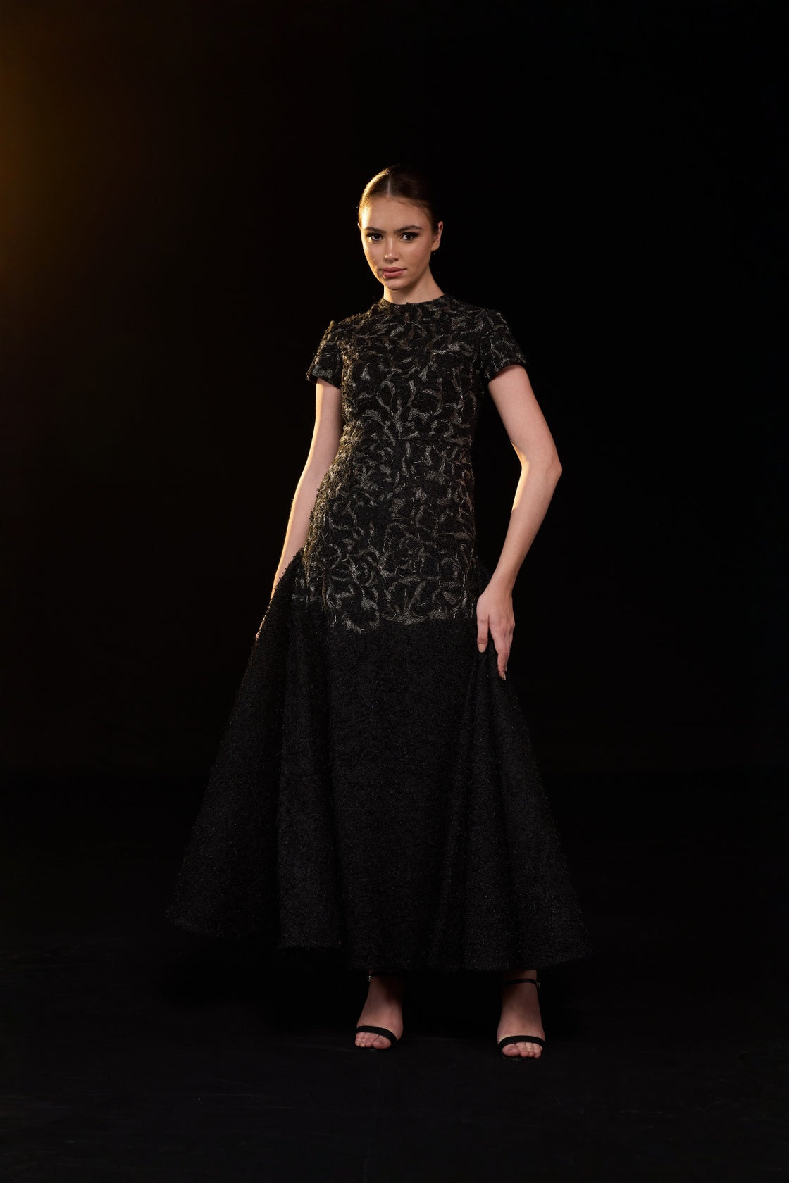 Black Textured Gown With Classic Round Neckline And Voluminous Flared Hem. Intricate Tonal Embellishments
