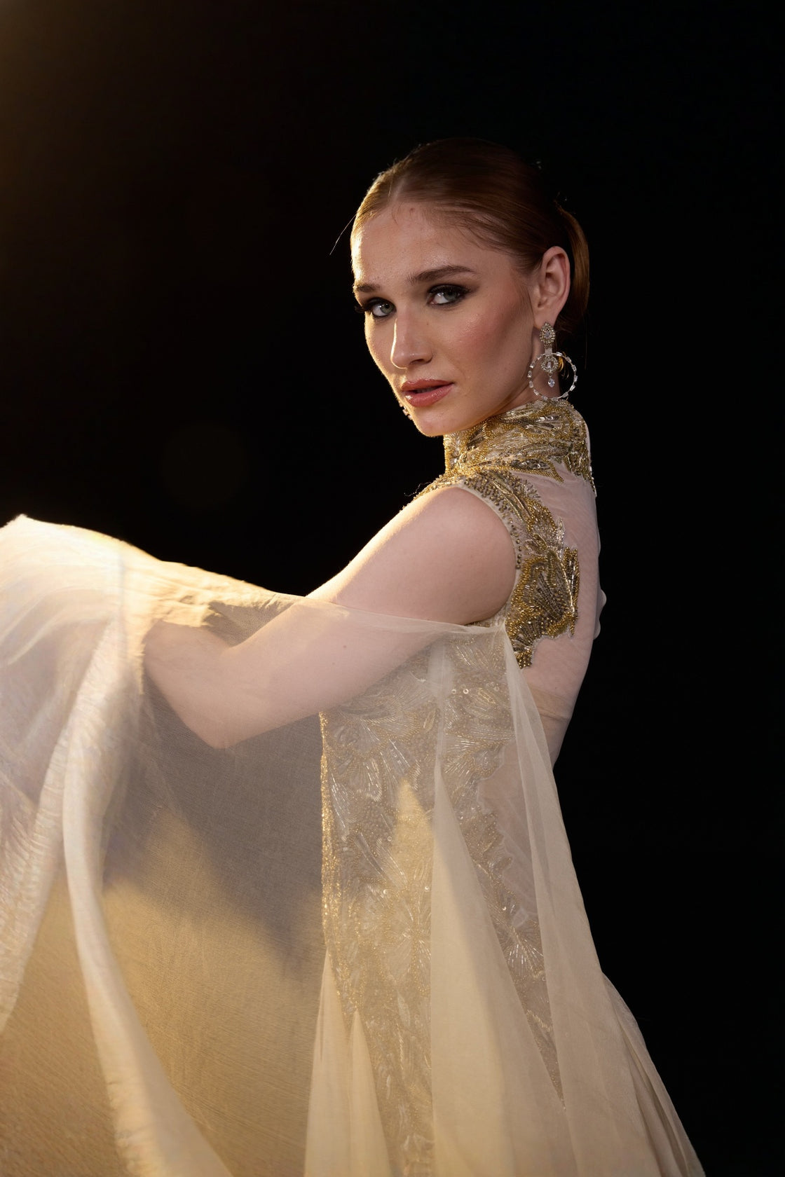 Beige Emebellished Gown With Illusion Neckline And Flowing Layered Drapes. Look Enhanced With A Trail