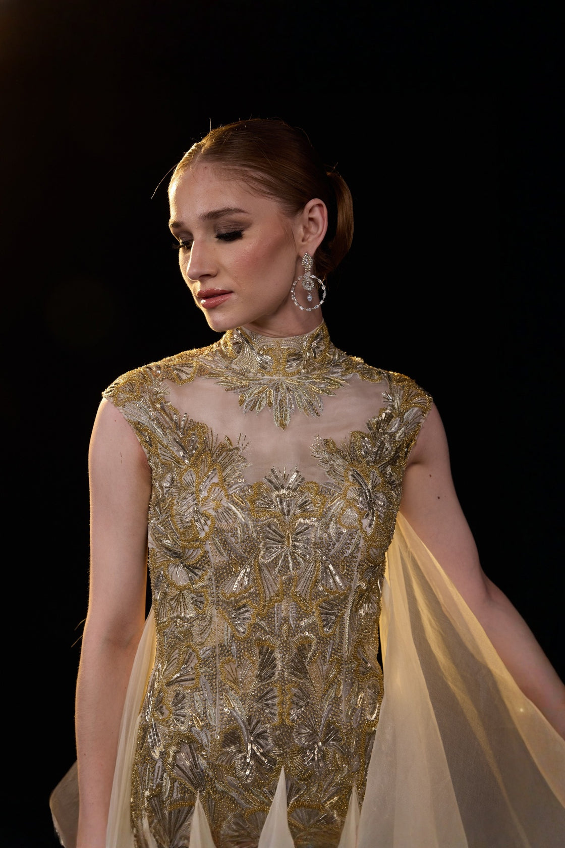 Beige Emebellished Gown With Illusion Neckline And Flowing Layered Drapes. Look Enhanced With A Trail
