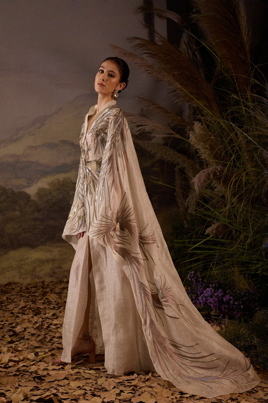 Ivory Embroidered Cape Dress With A V-Neckline , Flowing Draped Sleeves And Intricate Metallic Detailing