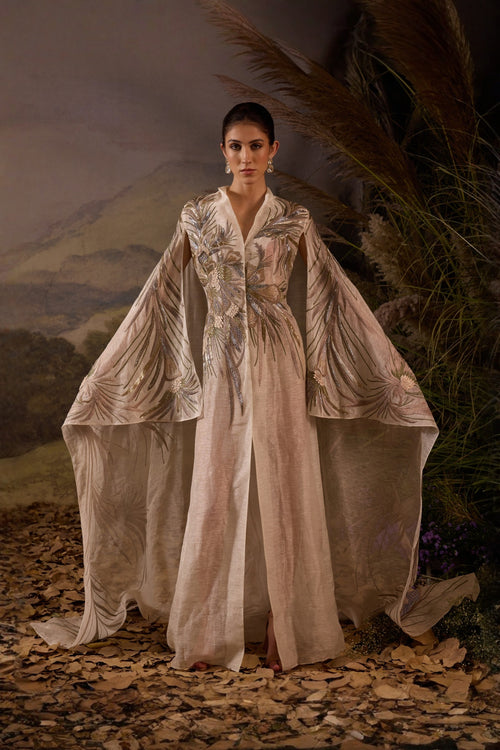Ivory Embroidered Cape Dress With A V-Neckline , Flowing Draped Sleeves And Intricate Metallic Detailing