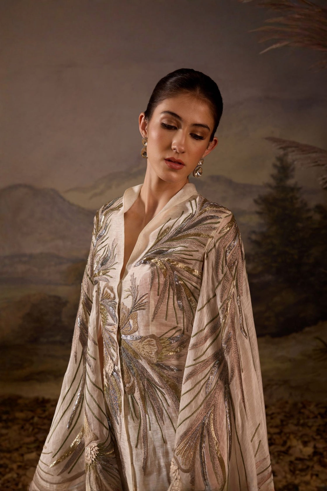 Ivory Embroidered Cape Dress With A V-Neckline , Flowing Draped Sleeves And Intricate Metallic Detailing