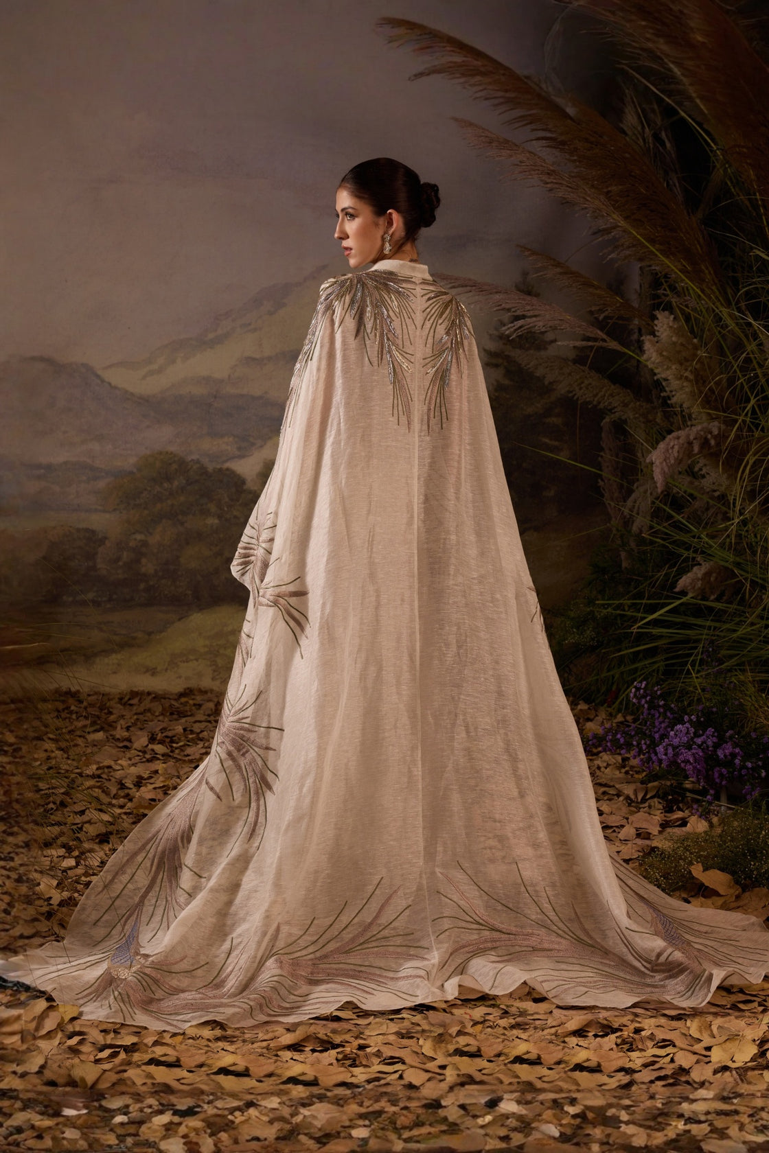 Ivory Embroidered Cape Dress With A V-Neckline , Flowing Draped Sleeves And Intricate Metallic Detailing