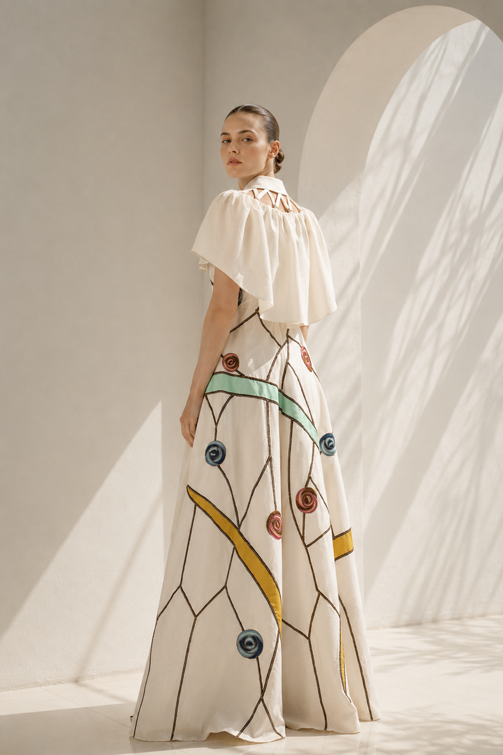 Ivory gown with embroidered cape drama