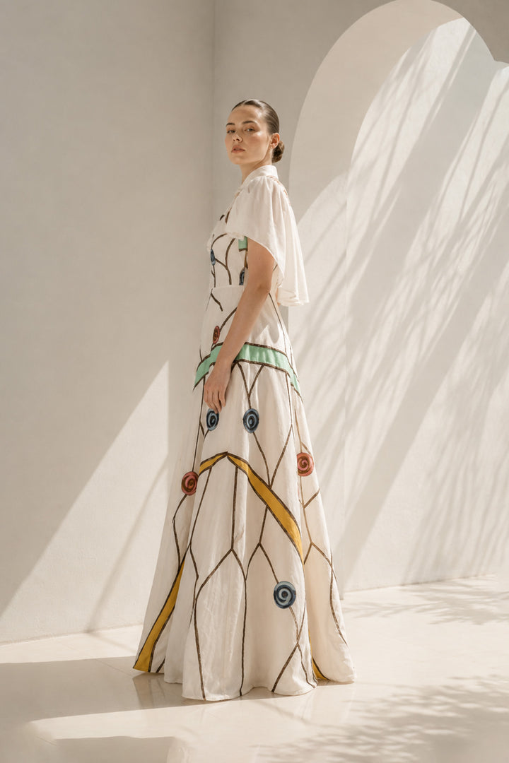 Ivory gown with embroidered cape drama