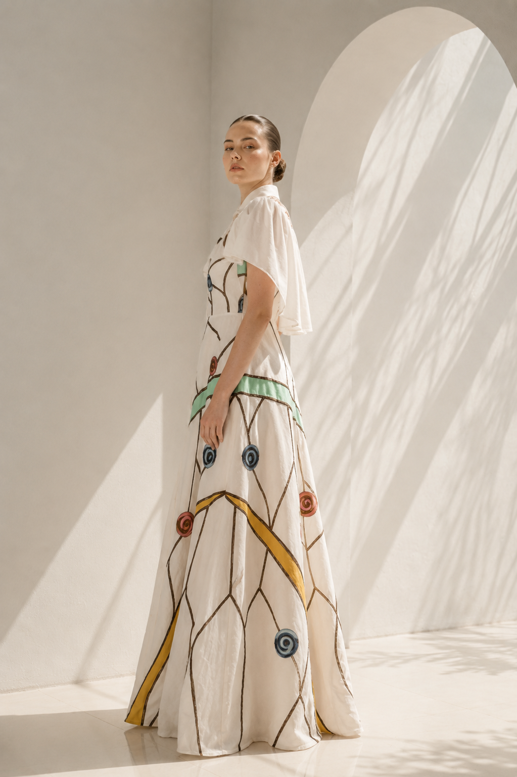 Ivory gown with embroidered cape drama
