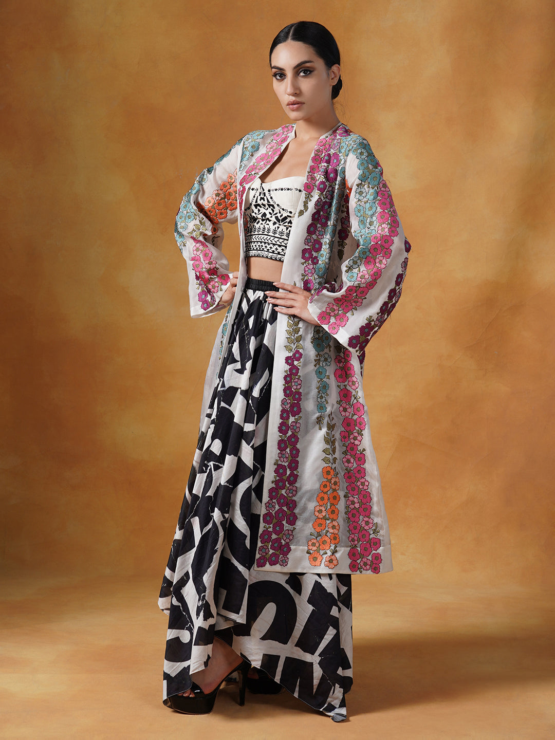 organza jacket adorned in beautiful silk thread floral embroidery over a white embellished tube to and printed skirt