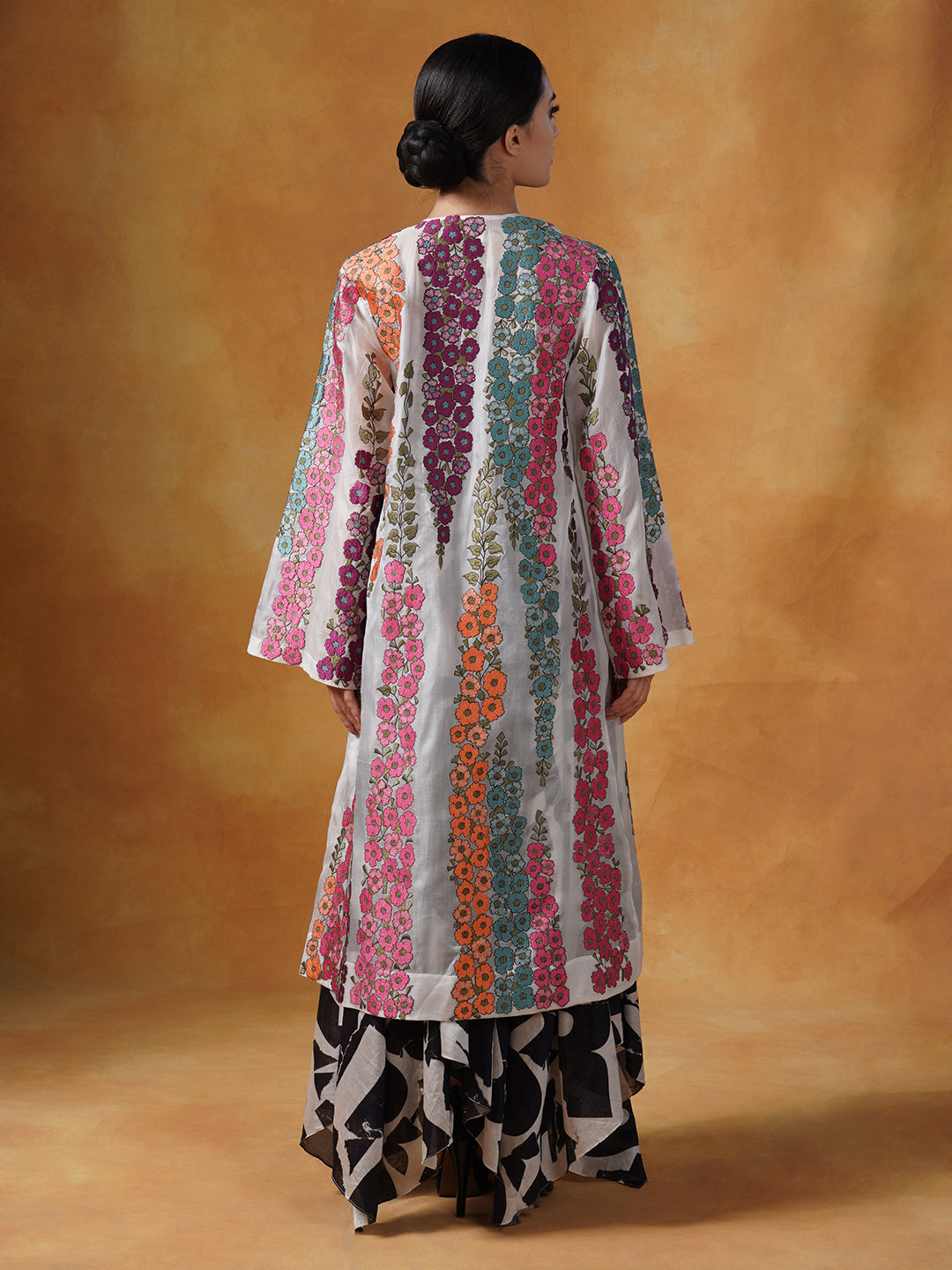 organza jacket adorned in beautiful silk thread floral embroidery over a white embellished tube to and printed skirt