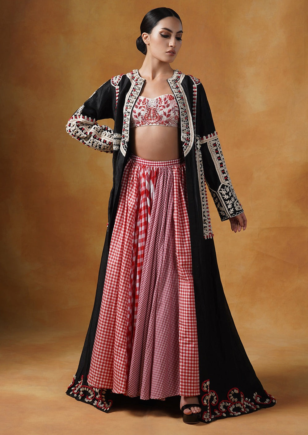 jacket is topped over a check skirt and embroidered blouse