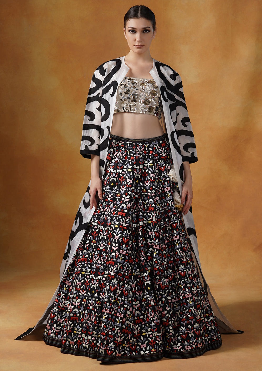organza jacket with black appliqué work, topped over a lehenga set