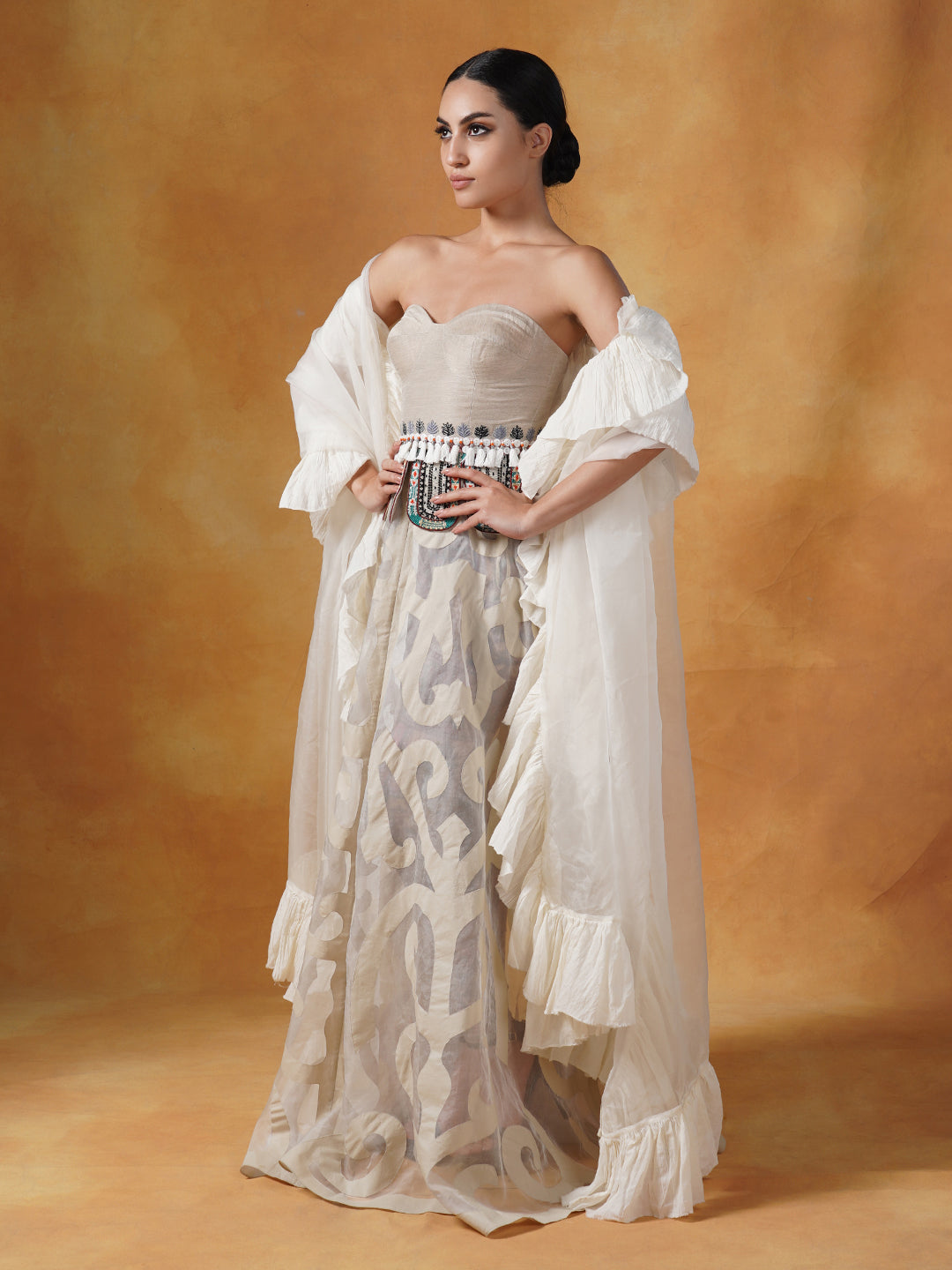 A tube corset in cotton paired with an Ivory appliqué work skirt and organza Dupatta with cotton frill.