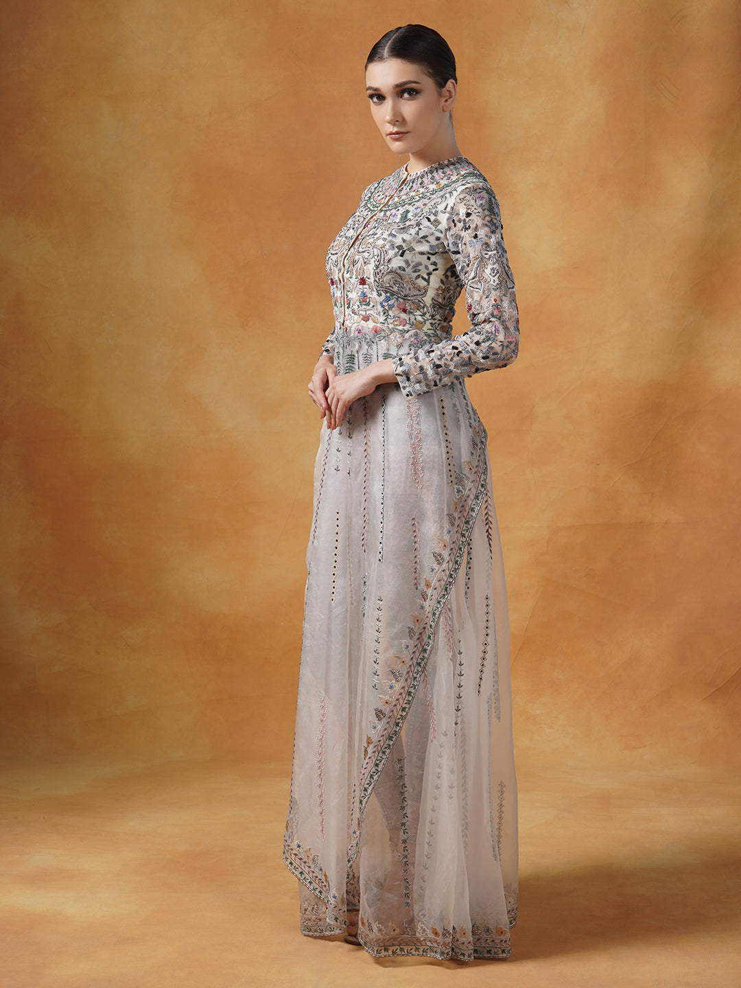 An organza jacket that is beautifully embroidered in silk yarns and pearl.