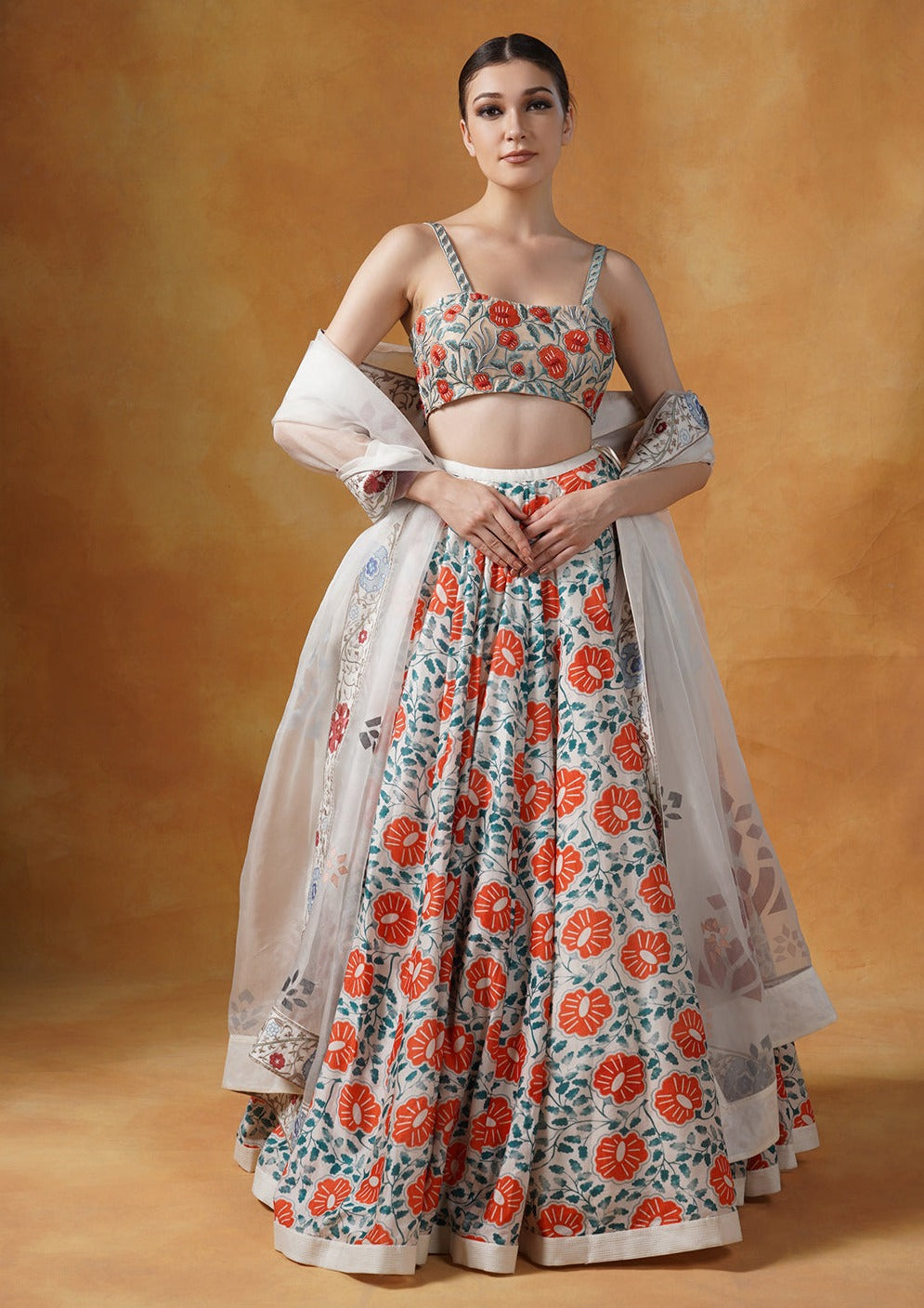 A printed lehenga set with intricately embroidered blouse and organza Dupatta