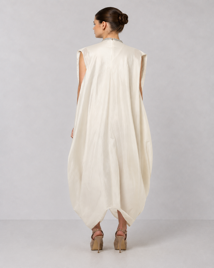 Ivory embroidered draped ensemble featuring floral threadwork, a fluid cowl silhouette, and contemporary cape-inspired styling