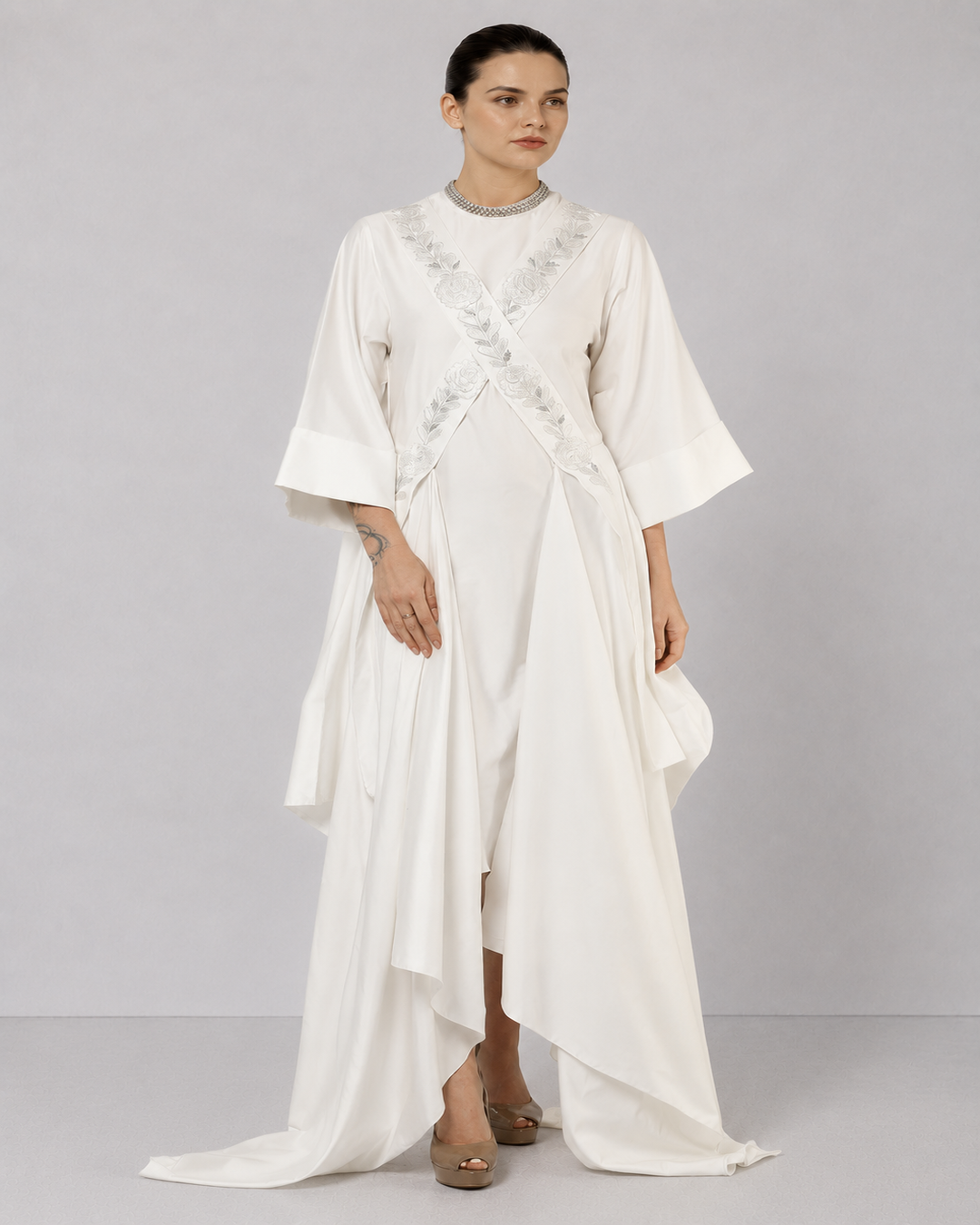 Ivory draped overlay dress with tonal floral embroidery, cascading panels, and relaxed statement sleeves.