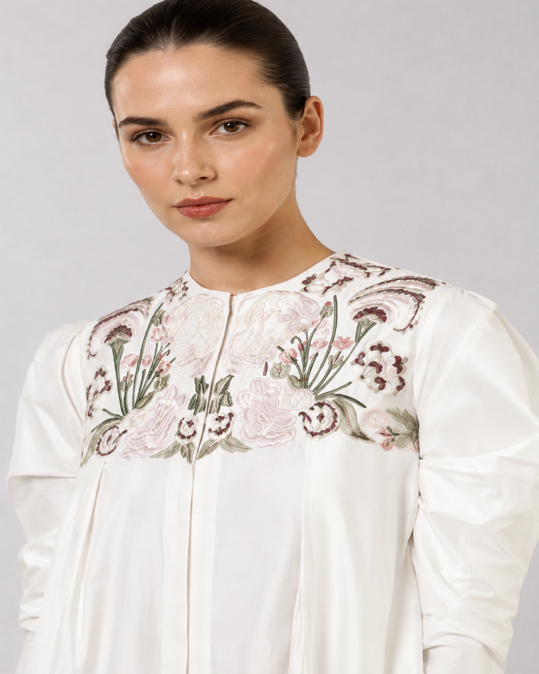 Ivory floral embroidered dress with statement puff sleeves and sculpted draped hem.