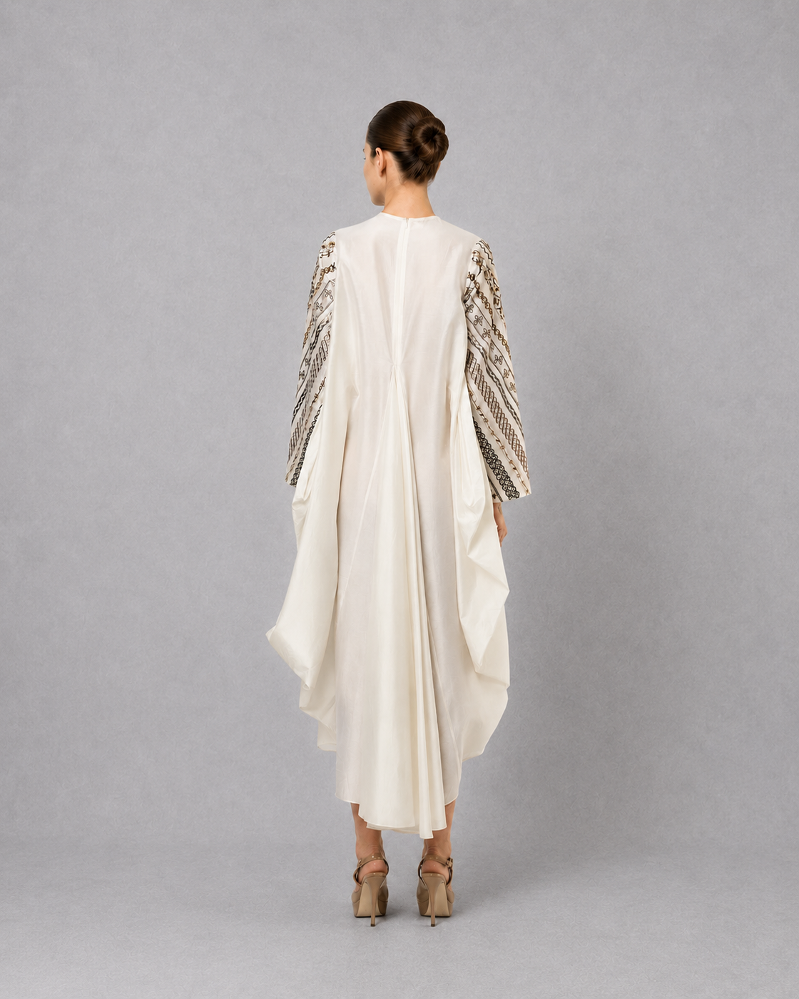 Ivory one-side pleated embroidered dress with asymmetrical hem.