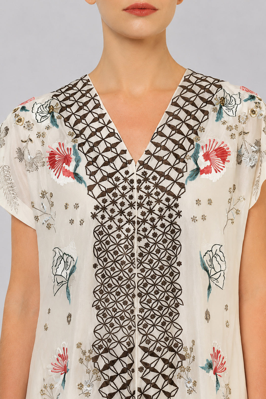 Ivory Embroidered Dress With Geometric Detailing And Layered Flared Hem.